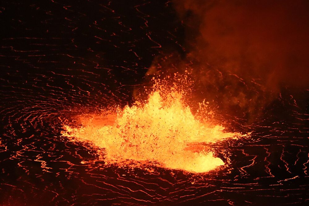 A fountain of molten lava bursting from the lava lake in Halemaʻumaʻu